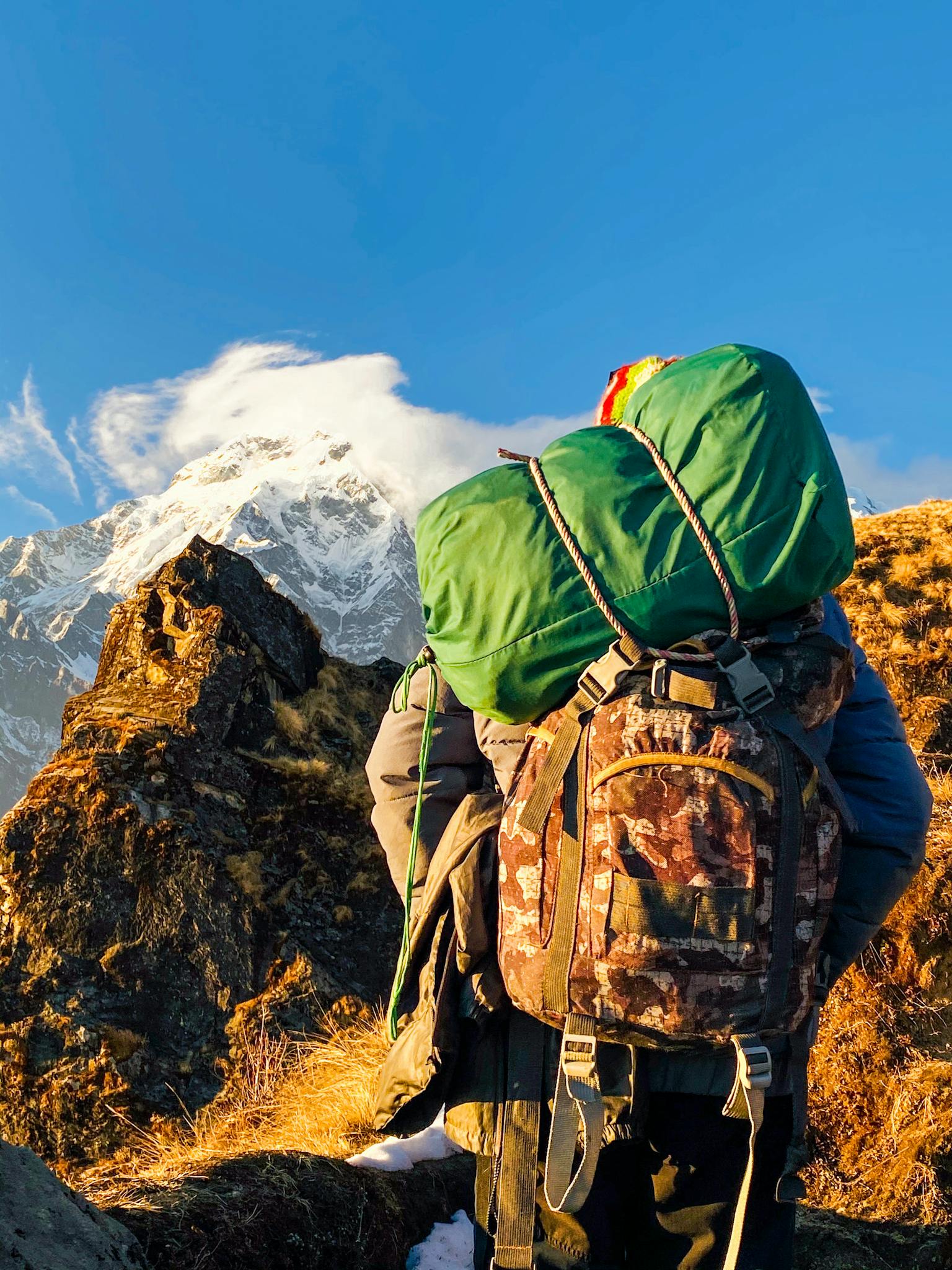 Anonymous hiker exploring mountainous terrain on sunny day